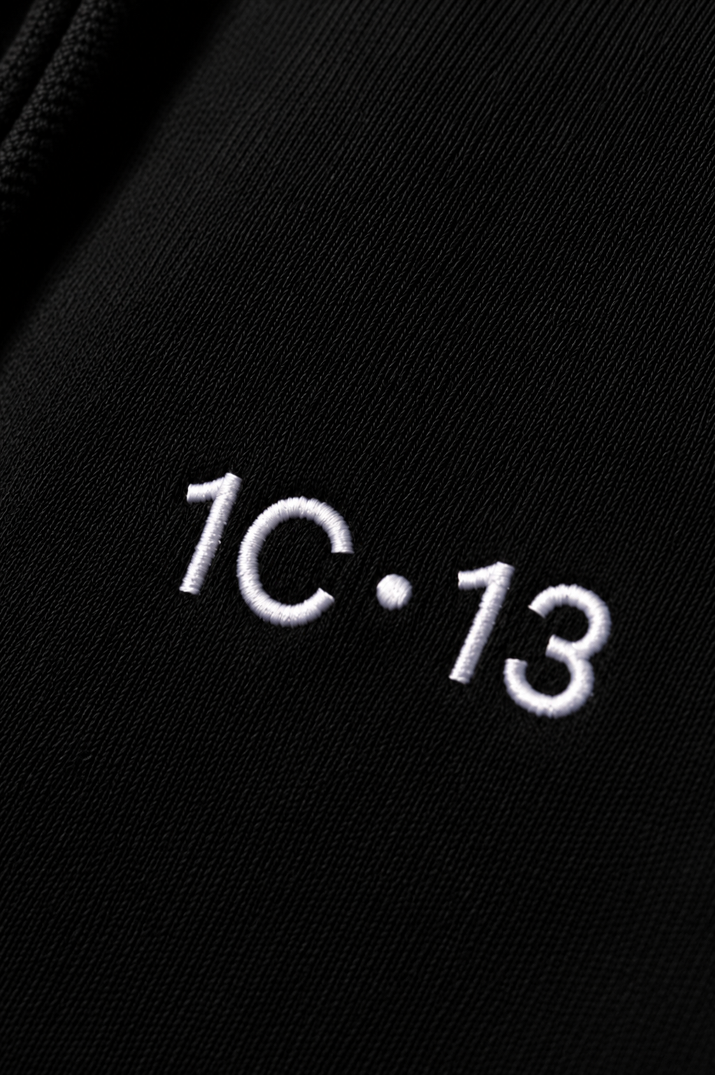 1C·13 embroidered logo detail on black hoodie