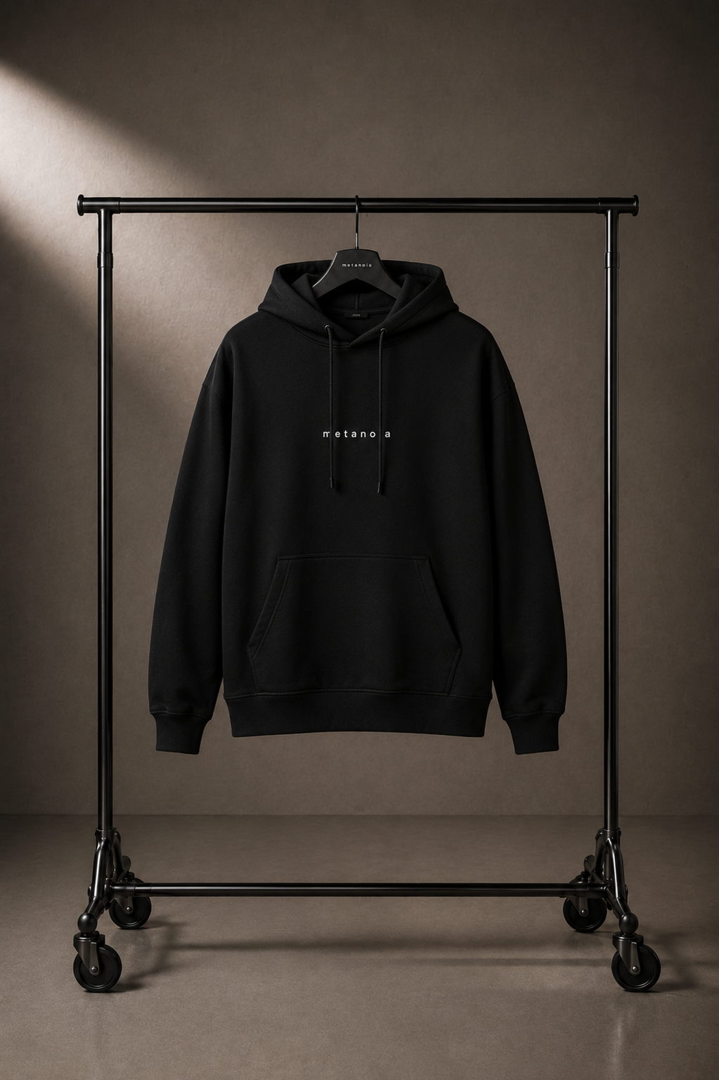 METANOIA Side-Pocket Hoodie in Black on hanger