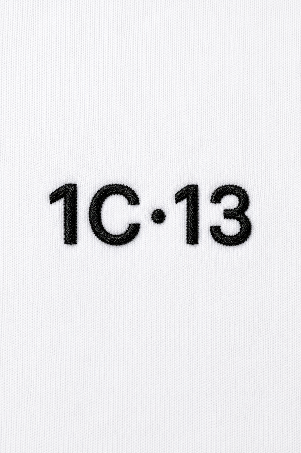 1C·13 embroidered logo detail on white hoodie