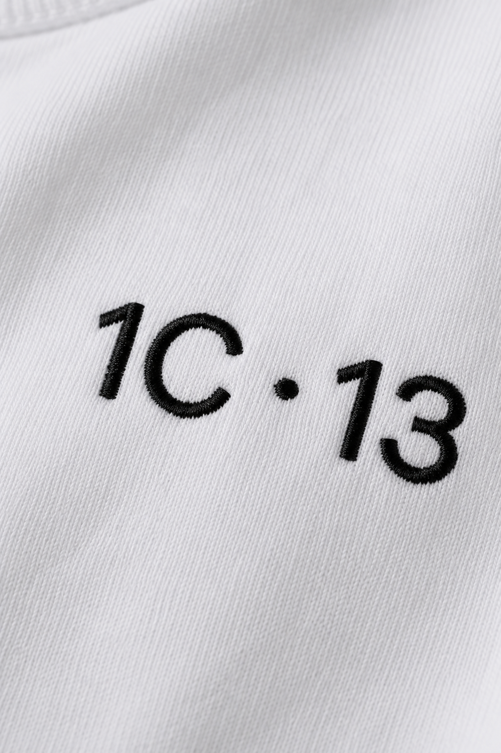 1C·13 embroidered logo detail on white tee